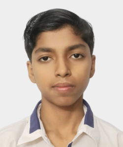 Portrait of a young boy facing the camera, wearing a white shirt with a blue collar, neutral expression, light background.