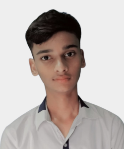 Young man with short dark hair in a light gray collared shirt, looking at the camera against a plain light background.