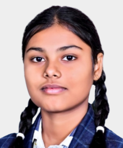 Portrait of a schoolgirl with two braids, wearing a blue plaid uniform and white shirt, facing the camera.