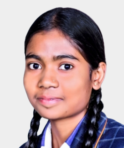 Portrait of a young girl with two braids wearing a blue plaid school uniform and a neutral expression.