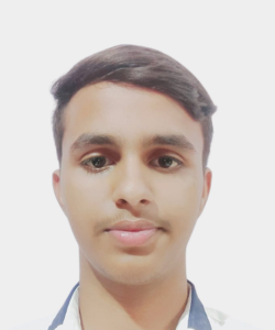 Close-up portrait of a young man with short dark hair looking at the camera, neutral expression, white background.